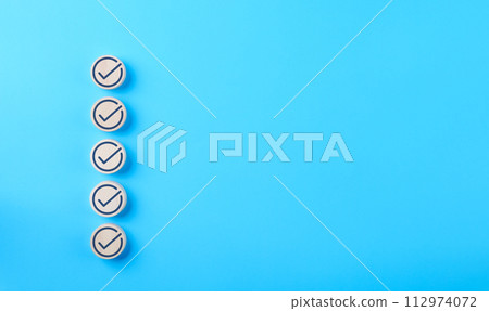 Checklist concept. Correct sign tick check mark on wooden block with copy space for the checklist on blue background. Business survey questionnaire, Exam test process, filling digital form online, 112974072