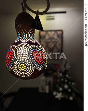 A gourd lamp is a unique and artistic lighting solution, crafted from dried and hollowed-out gourd fruits, these lamps are meticumeticulously handcrafted to create patterns A gourd lamp is a unique and artistic lighting solution, crafted from dried and hollowed-out gourd fruits, these lamps are meticumeticulously handcrafted to create patterns 112974306