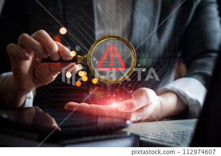 A manager examines an alert with a magnifying glass i. A manager examines an alert with a magnifying glass i. 112974607