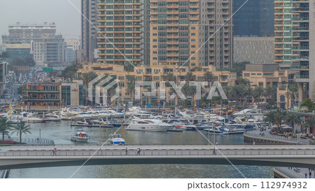Beautiful aerial top view day to night transition timelapse of Dubai Marina canal Beautiful aerial top view day to night transition timelapse of Dubai Marina canal 112974932