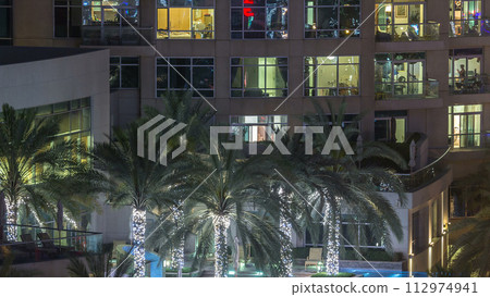 Rooftop swimming pool in Dubai marina night timelapse 112974941