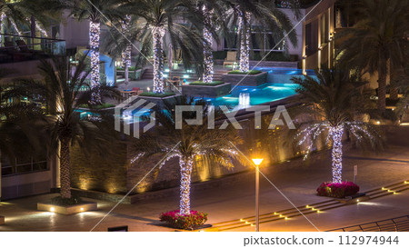 Rooftop swimming pool in Dubai marina night timelapse 112974944