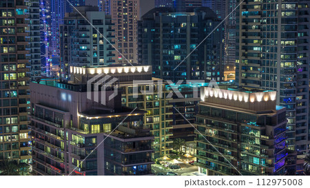 Water canal on Dubai Marina skyline at night timelapse. 112975008