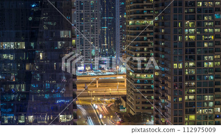 Water canal on Dubai Marina skyline at night timelapse. 112975009