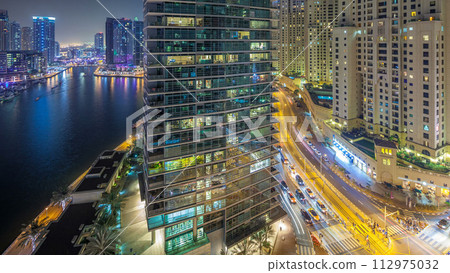Night illumination of Dubai Marina aerial timelapse, UAE. 112975032