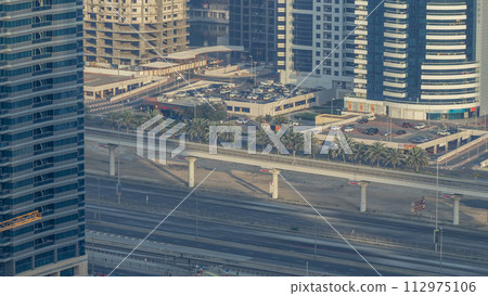 Amazing rooftop view on Sheikh Zayed road surrounded Dubai Marina and JLT skyscrapers timelapse Amazing rooftop view on Sheikh Zayed road surrounded Dubai Marina and JLT skyscrapers timelapse 112975106