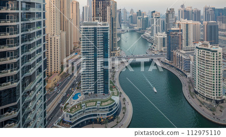 Beautiful aerial top view day to night transition timelapse of Dubai Marina canal 112975110