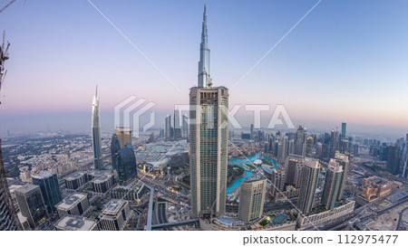 Dubai Downtown day to night timelapse modern towers panoramic view from the top in Dubai, United Arab Emirates. 112975477