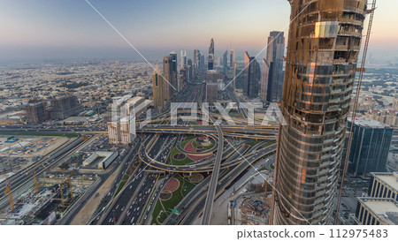 Scenic Dubai downtown skyline day to night timelapse. Rooftop view of Sheikh Zayed road 112975483