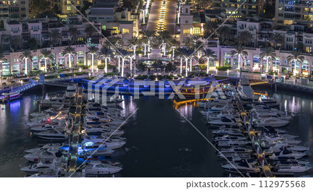 Dubai Marina fountain aerial night timelapse, port with luxury yachts and marina promenade 112975568