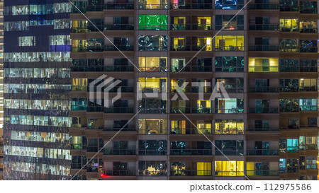 Scenic glowing windows of skyscrapers at evening timelapse 112975586