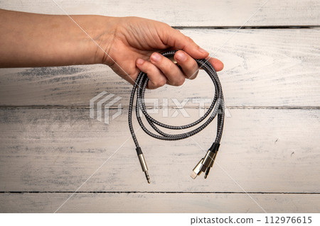 3 In 1 Type-C3.5mm Jack Aux Cable in hand. White background 112976615