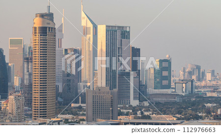 Dubai Downtown at sunset timelapse. Aerial view over big futuristic city. Dubai Downtown at sunset timelapse. Aerial view over big futuristic city. 112976663