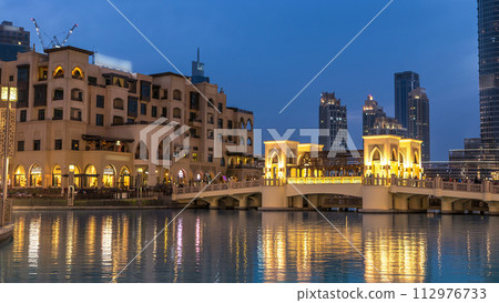The bridge near the biggest musical fountain in Dubai day to night timelapse. Dubai, UAE The bridge near the biggest musical fountain in Dubai day to night timelapse. Dubai, UAE 112976733