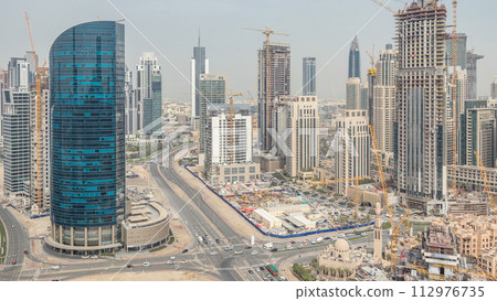 Downtown Dubai and business bay skyline with residential towers timelapse, view from rooftop. 112976735