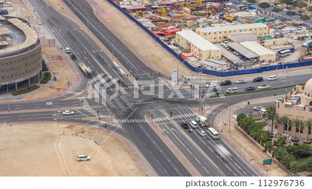 Top view city traffic on a crossroad in Dubai Downtown timelapse. 112976736