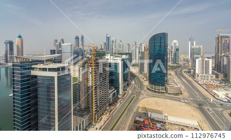 Dubai business bay towers at day time aerial timelapse. 112976745