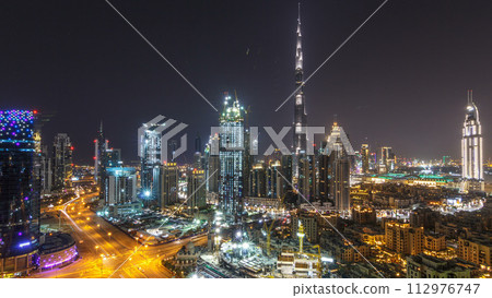 Aerial cityscape timelapse at night with illuminated modern architecture in Downtown of Dubai, United Arab Emirates. Aerial cityscape timelapse at night with illuminated modern architecture in Downtown of Dubai, United Arab Emirates. 112976747