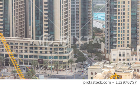 Downtown Dubai skyline with residential towers timelapse, view from rooftop. 112976757
