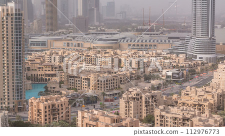 Downtown Dubai skyline with residential towers timelapse, view from rooftop. Downtown Dubai skyline with residential towers timelapse, view from rooftop. 112976773