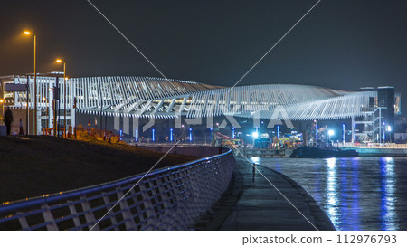 New pedestrian bridge over the Dubai Water Canal illuminated at night timelapse. United Arab Emirates, Middle East 112976793