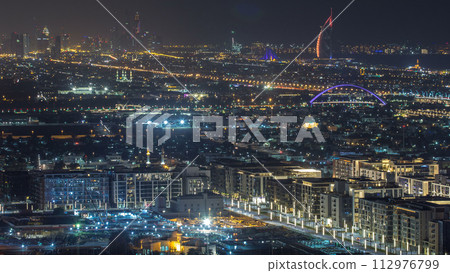 Dubai skyline with Dubai Marina skyscrapers and coastline at dusk timelapse with seven star luxury hotel in Dubai, UAE. 112976799