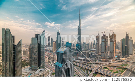 Dubai skyline timelapse at sunset with city center skyscrapers and Sheikh Zayed road traffic, Dubai, United Arab Emirates 112976820