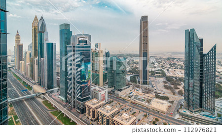 Dubai skyline timelapse at sunset with city center skyscrapers and Sheikh Zayed road traffic, Dubai, United Arab Emirates Dubai skyline timelapse at sunset with city center skyscrapers and Sheikh Zayed road traffic, Dubai, United Arab Emirates 112976821