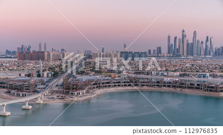Jumeirah Palm island skyline day to night timelapse in Dubai, UAE. Jumeirah Palm island skyline day to night timelapse in Dubai, UAE. 112976835