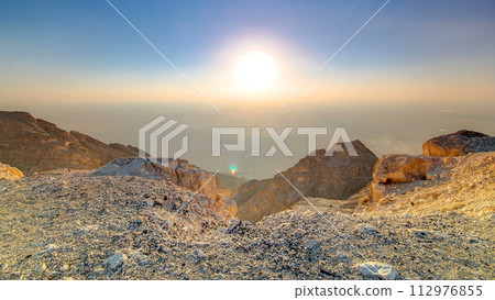 Sunset with rocks timelapse. Jebel Hafeet is a mountain located primarily in the environs of Al Ain 112976855