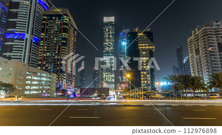Downtown Dubai towers night timelapse hyperlapse. View of Sheikh Zayed road with tall skyscrapers. 112976898