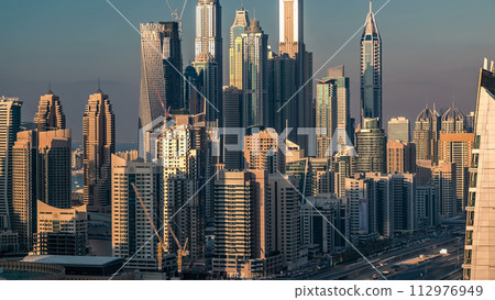 Aerial top view at sunset timelapse of Dubai Marina and JLT in Dubai, UAE Aerial top view at sunset timelapse of Dubai Marina and JLT in Dubai, UAE 112976949