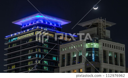 Downtown Dubai towers night timelapse. Aerial view of Sheikh Zayed road with skyscrapers. Downtown Dubai towers night timelapse. Aerial view of Sheikh Zayed road with skyscrapers. 112976962