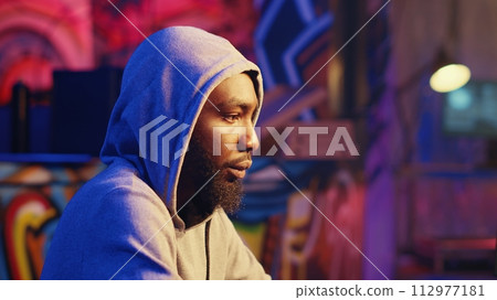 Close up shot of hacker excited about finally finding ways to breach defenses and exploit weaknesses in PC systems. African american cybersecurity expert getting past companies security networks 112977181