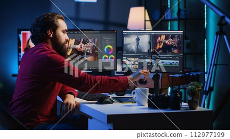Video editor content creator pressing record button on phone, filming tutorial about professionally trimming footage segments. Videographer teaching online audiences to splice clips 112977199