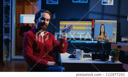 Photographer filming content for online streaming platform, discussing about software used to perform image editing. Photo editor recording video offering tips on making photographs adjustments 112977201
