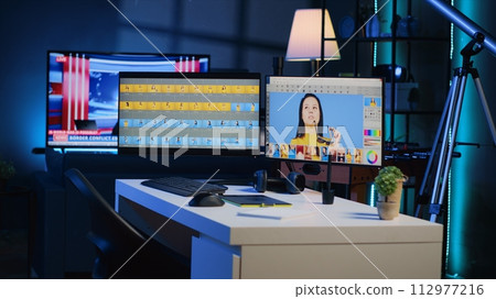 Photo processing software interface on computer screens in creative agency studio, panning shot. Image editing program UI displayed on multi monitors PC setup in photographer workspace 112977216