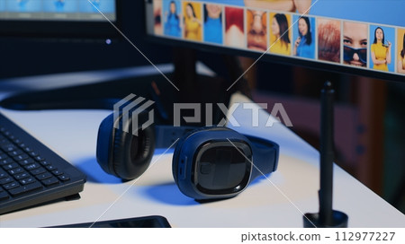 Close up shot of graphic design agency office desk computer screens used for photo processing, graphic tablet and professional camera, dolly out shot. Photography tools on table used by photographer Close up shot of graphic design agency office desk computer screens used for photo processing, graphic tablet and professional camera, dolly out shot. Photography tools on table used by photographer 112977227