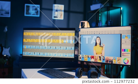 Photo retouching software interface on computer in empty blue neon lit photography studio. Photography organizing program displayed on multi monitors PC setup on multimedia agency desk, zoom out shot Photo retouching software interface on computer in empty blue neon lit photography studio. Photography organizing program displayed on multi monitors PC setup on multimedia agency desk, zoom out shot 112977232