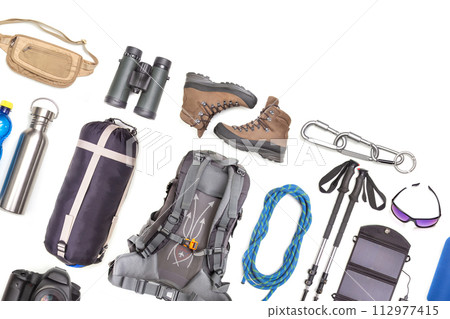 Set of tourist trekking items on white background. Top view of accessories for travel 112977415