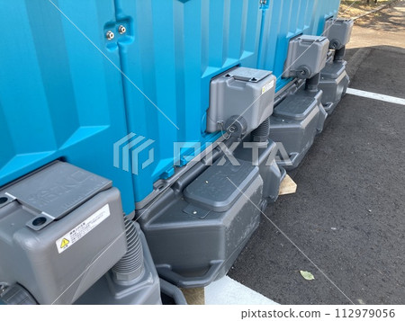 The back side of a temporary toilet installed on the street 112979056