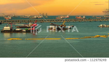 Industry landscape on sunset Engineering shipping crane depot at logistic export terminal control. Silhouette Warehouse freight background container yard loading quayside harbor port with copyspace Industry landscape on sunset Engineering shipping crane depot at logistic export terminal control. Silhouette Warehouse freight background container yard loading quayside harbor port with copyspace 112979249