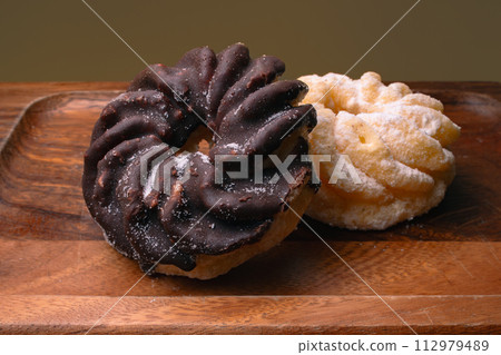 French cruller chocolate donut overhead view French cruller chocolate donut overhead view 112979489