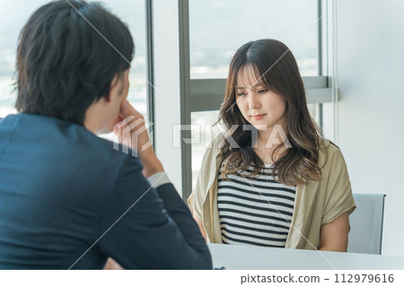 女性和男性律師/顧問（憂鬱/困擾/擔憂）在律師事務所/個人諮詢會議上諮詢煩惱 112979616