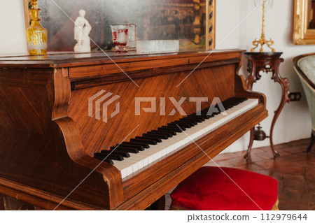 Grand vintage piano in the old house Grand vintage piano in the old house 112979644