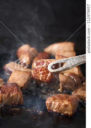 grill cut steak on iron plate 112979957