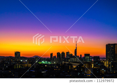 Dusk and twilight of Momochihama, Jigyohama, and Fukuoka Tower areas in Sawara Ward seen from Tojinmachi/Ohori Park. Night color brightness emphasized. 112979972