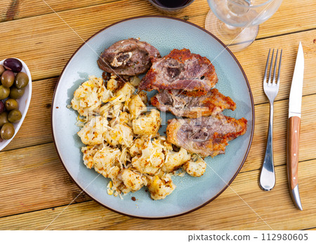 Fried fatty and juicy lamb and vegetable side dish of cauliflower with wine and olives Fried fatty and juicy lamb and vegetable side dish of cauliflower with wine and olives 112980605