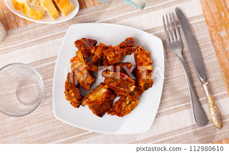 Appetizing delicious fried pork ribs on plate. Nutritious lunch Appetizing delicious fried pork ribs on plate. Nutritious lunch 112980610
