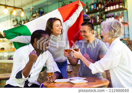 Joyful fans of the Italian team celebrating the victory in night bar 112980680